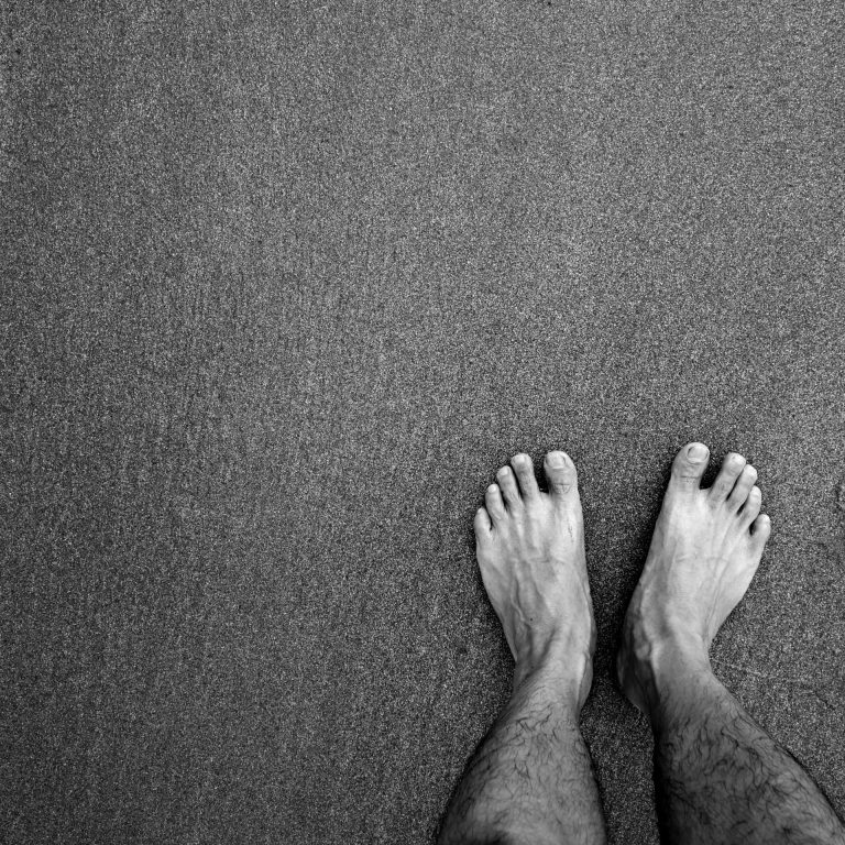 Feet of Asian male on the beach